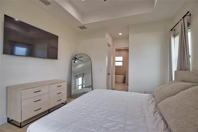 a bedroom with a large bed and a dresser