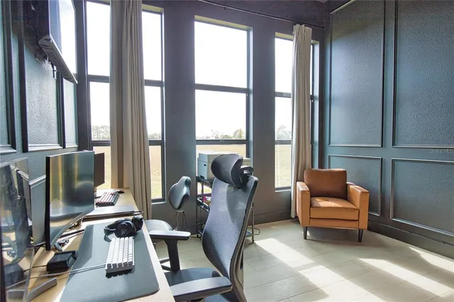 a room with furniture and two windows