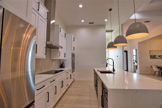 a kitchen with stainless steel appliances a refrigerator and a sink