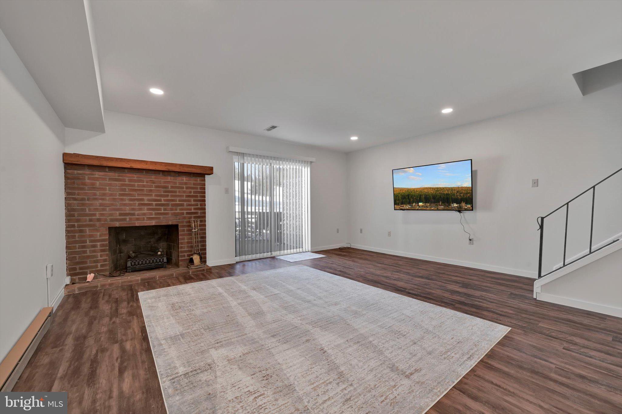 2604 Village Road Orwigsburg, PA 17961 - Photo 5 of 24 a view of empty room with wooden floor and fireplace