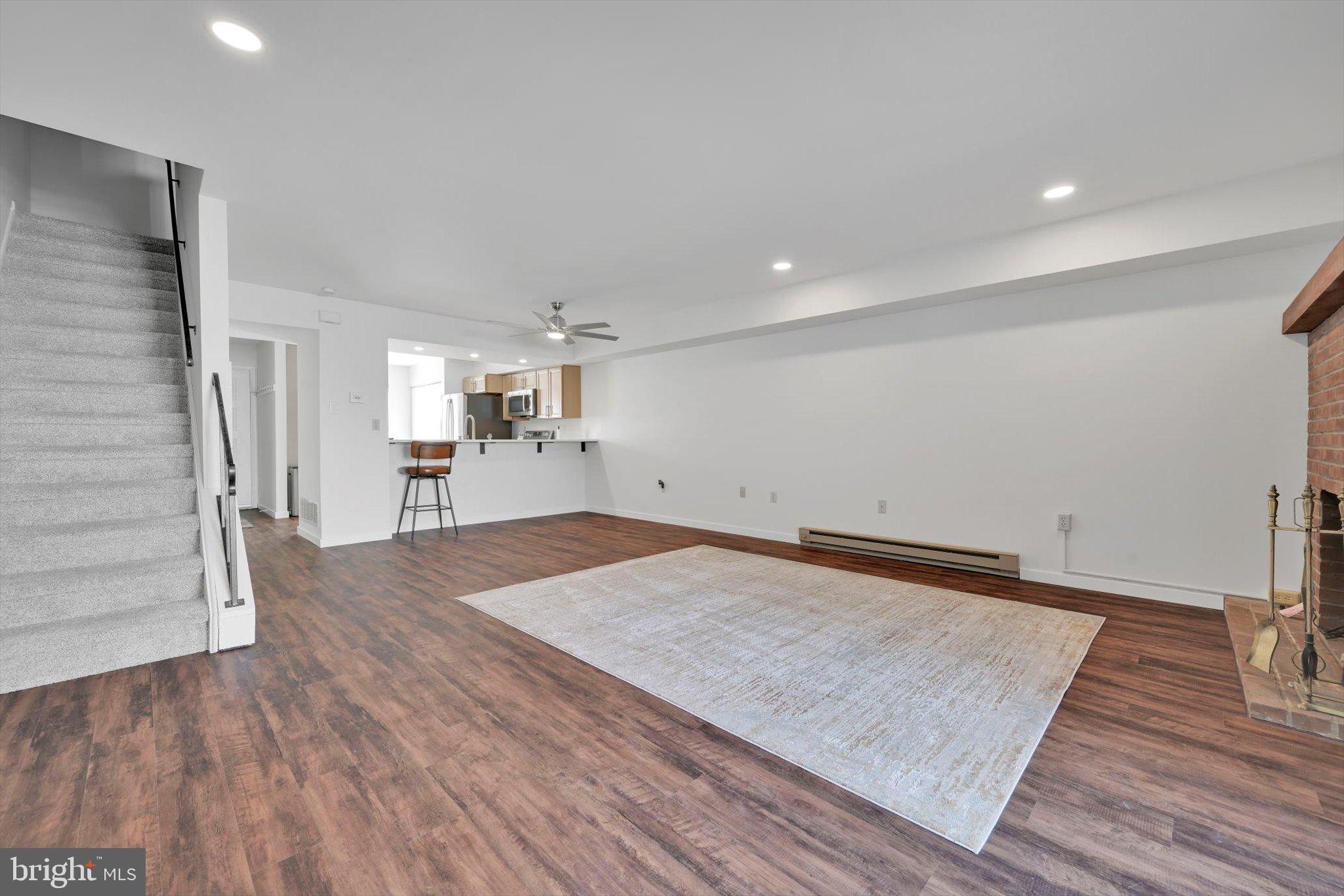 2604 Village Road Orwigsburg, PA 17961 - Photo 6 of 24 an empty room with wooden floor and staircase