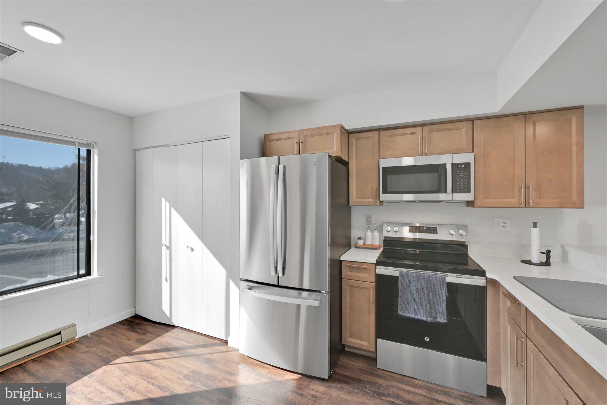 2604 Village Road Orwigsburg, PA 17961 - Photo 10 of 24 a kitchen with a refrigerator stove and microwave