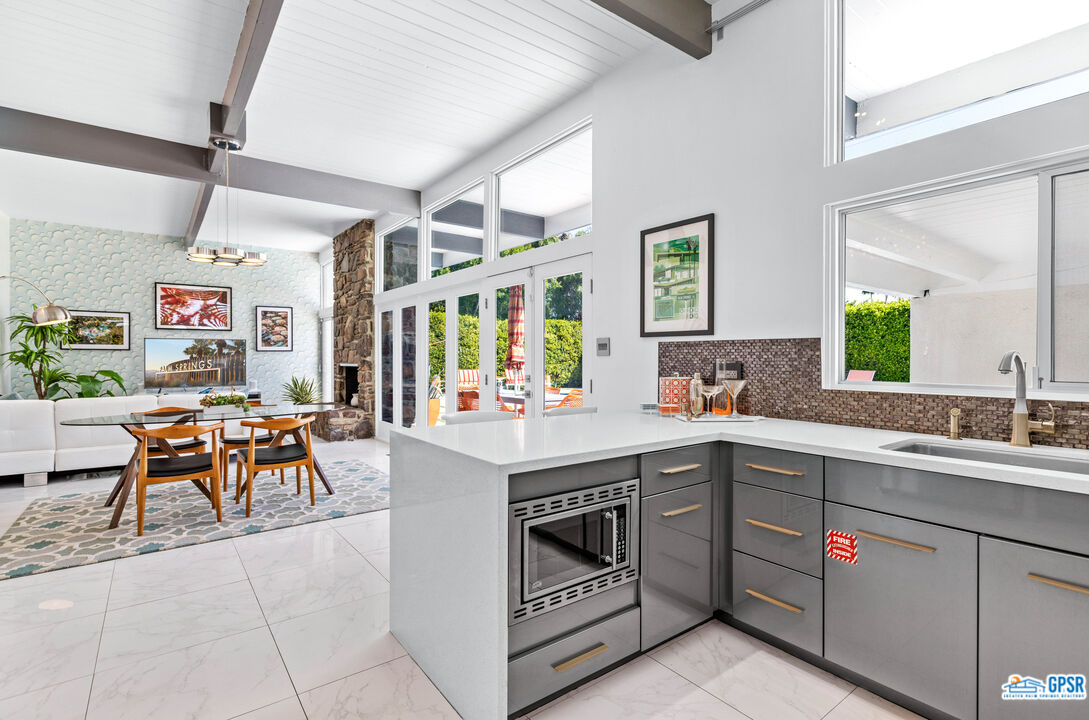 1008 Apache Road Palm Springs, CA 92264 - Photo 12 of 55 a kitchen with a sink stove and cabinets