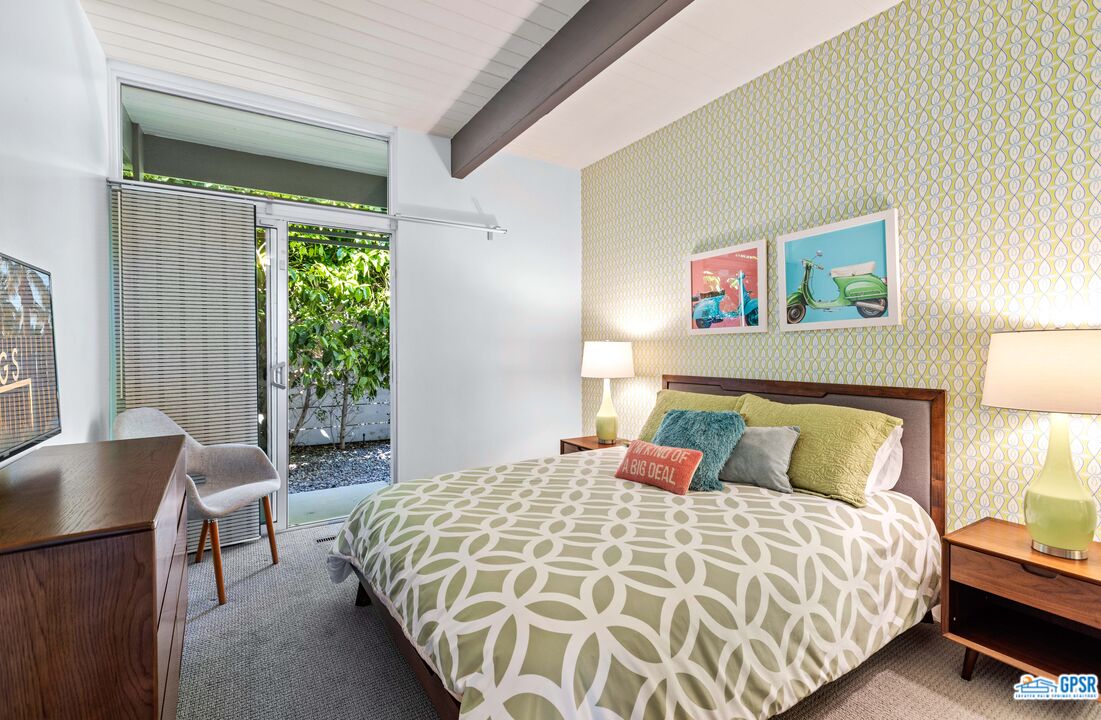 1008 Apache Road Palm Springs, CA 92264 - Photo 15 of 55 a bedroom with a bed and wooden floor