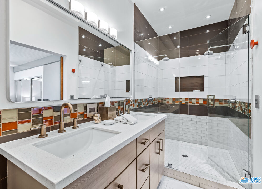 1008 Apache Road Palm Springs, CA 92264 - Photo 23 of 55 a bathroom with a sink a large mirror and a bathtub