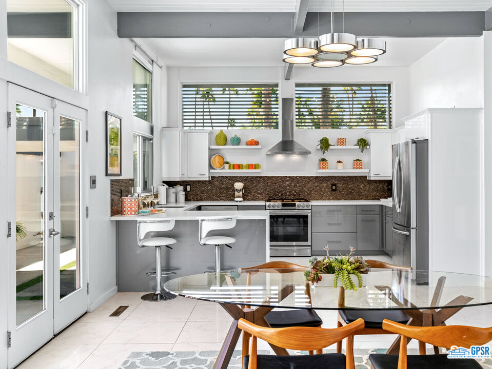1008 Apache Road Palm Springs, CA 92264 - Photo 10 of 55 a kitchen with stainless steel appliances granite countertop a refrigerator and a stove