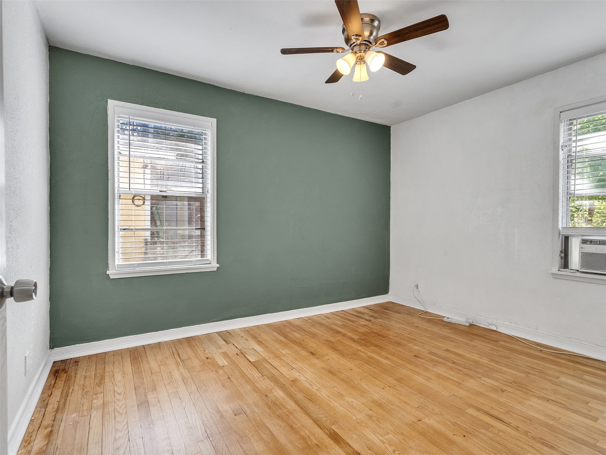 6942 Peyton Street Houston, TX 77028 - Photo 15 of 33 a view of empty room with wooden floor and fan