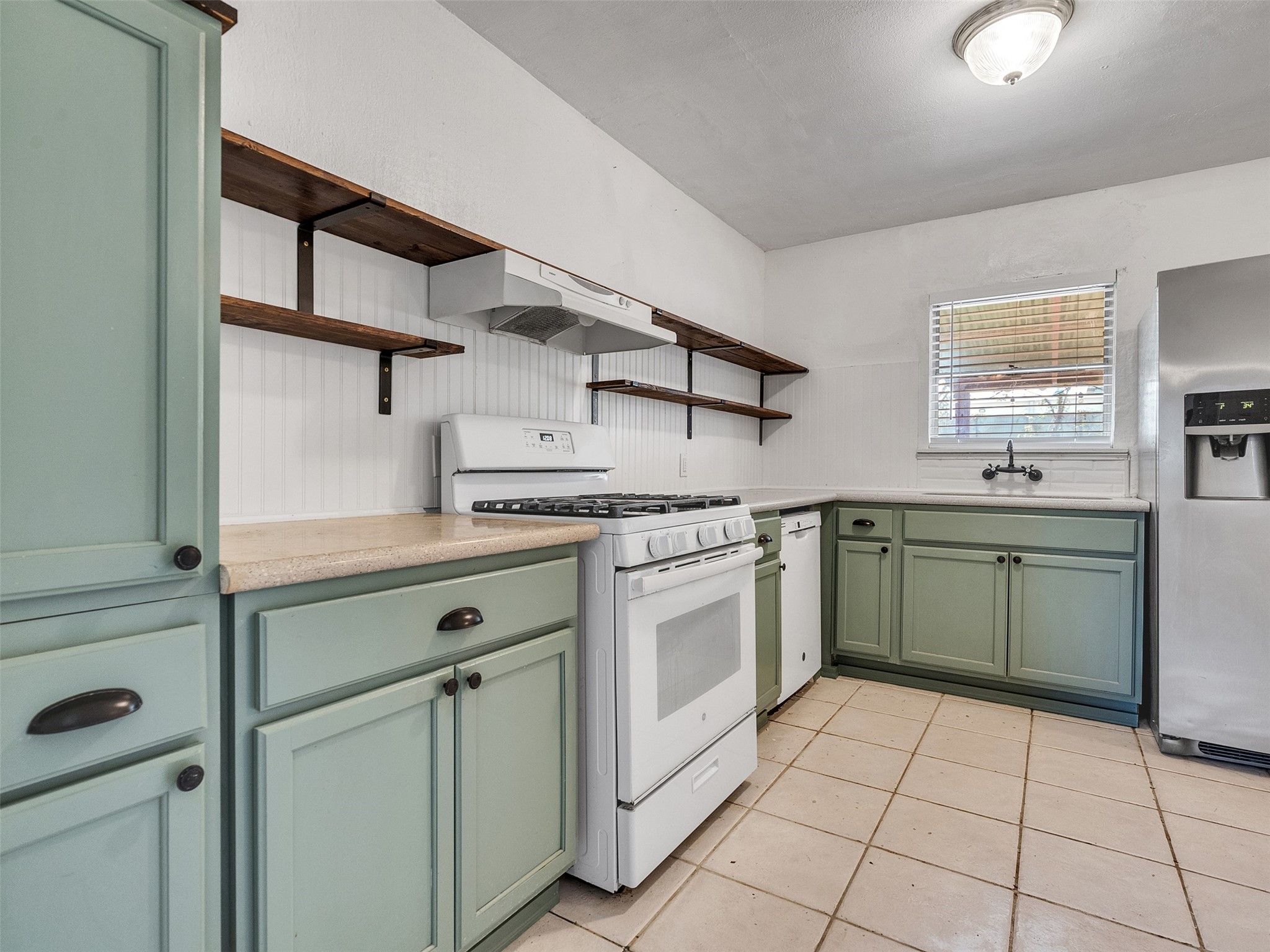 6942 Peyton Street Houston, TX 77028 - Photo 17 of 33 a kitchen with a stove sink and cabinets