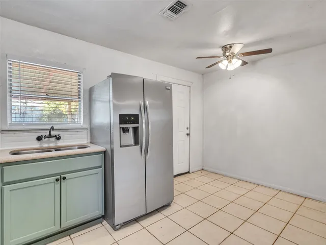 a kitchen with a sink appliances and cabinets