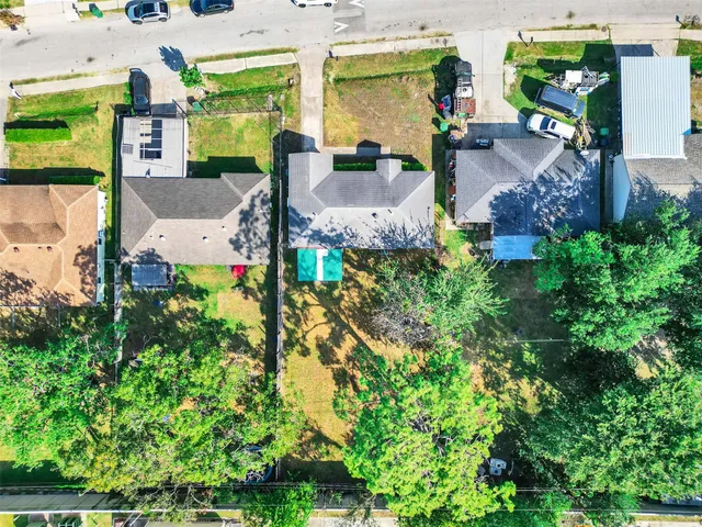an aerial view of a house with a yard basket ball court and outdoor seating