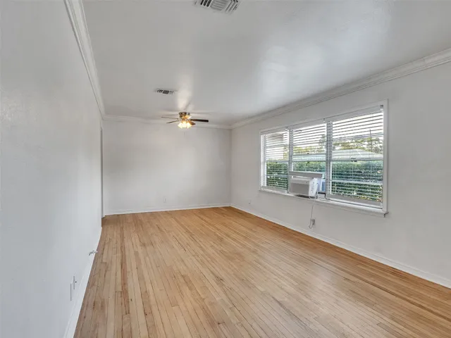 wooden floor in an empty room with a window