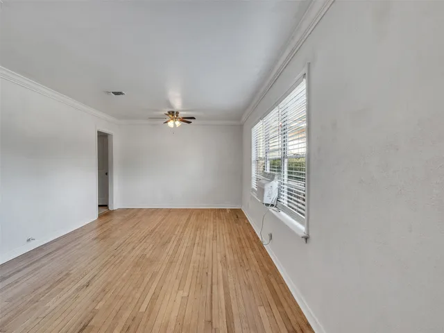 wooden floor in an empty room with a window