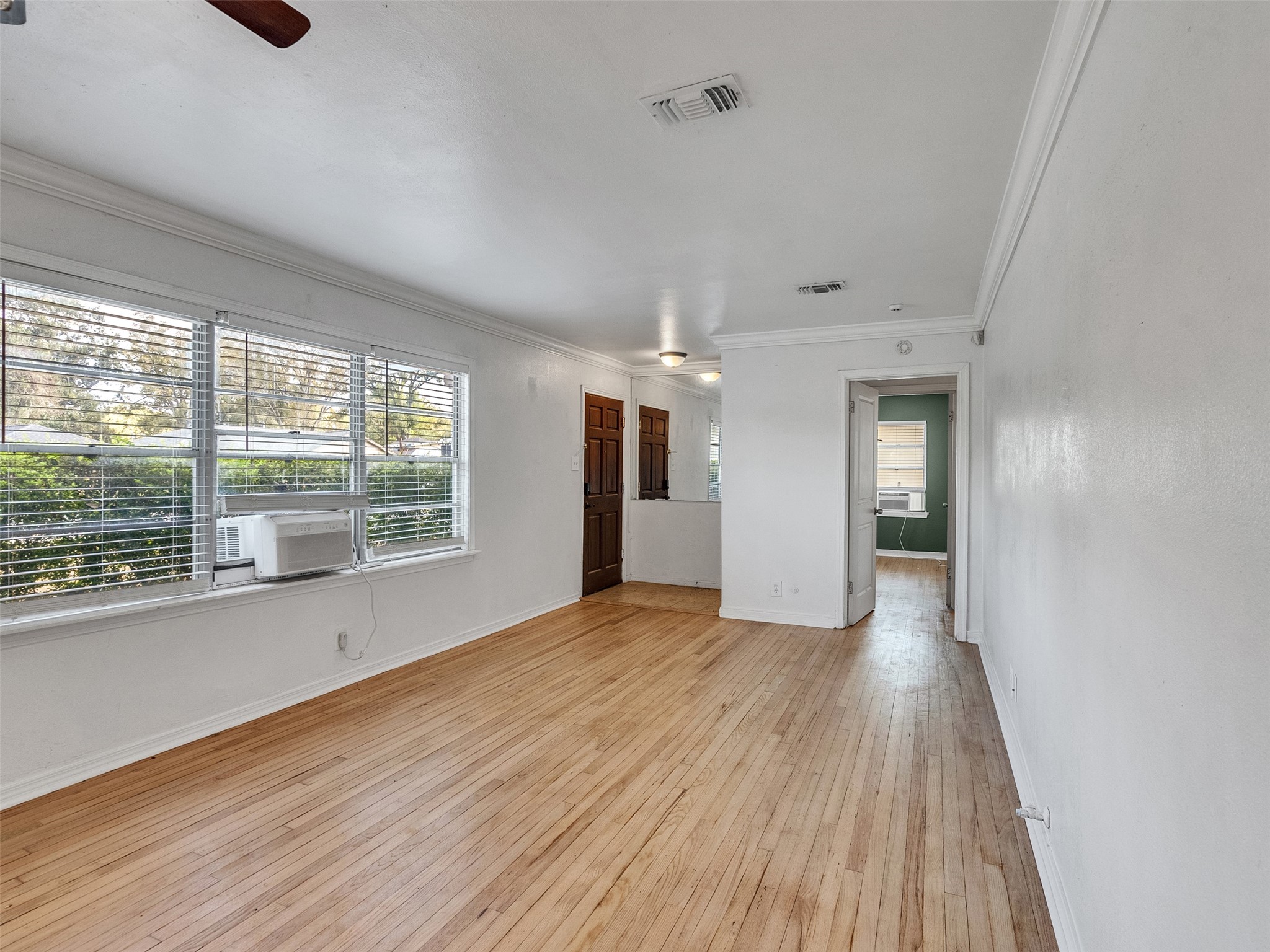6942 Peyton Street Houston, TX 77028 - Photo 6 of 33 a view of empty room with wooden floor and fan