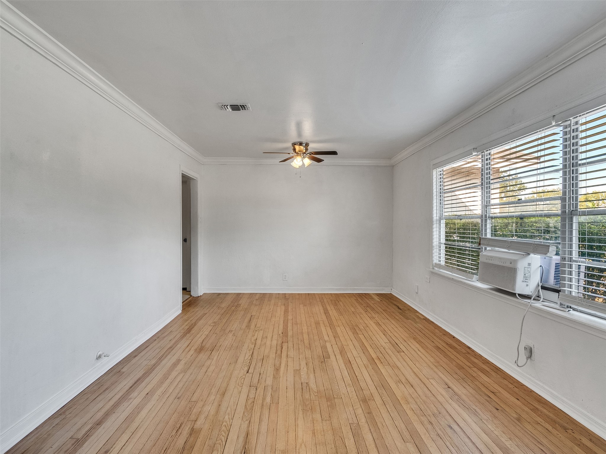 6942 Peyton Street Houston, TX 77028 - Photo 7 of 33 wooden floor in an empty room with a window