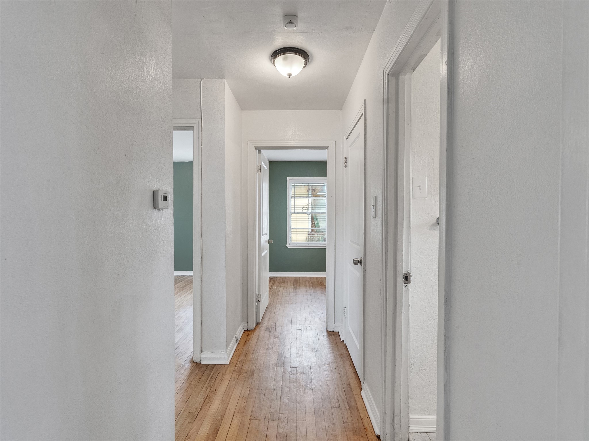 6942 Peyton Street Houston, TX 77028 - Photo 9 of 33 a view of a hallway with wooden floor