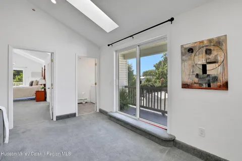 a view of hallway with livingroom and stairs