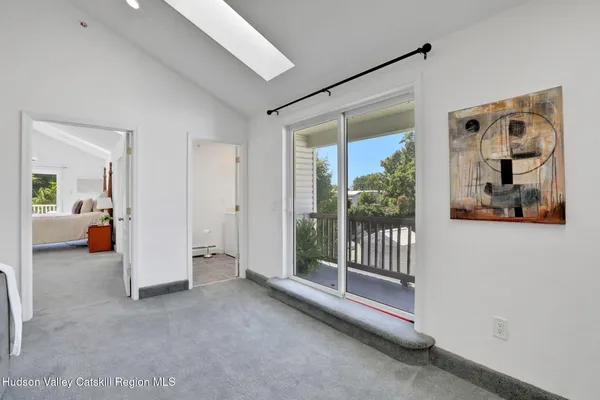 a view of hallway with livingroom and stairs