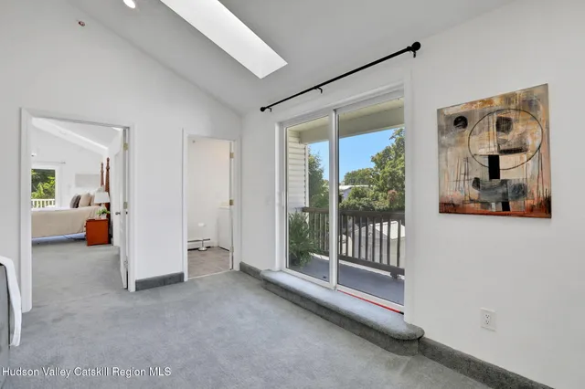 a view of hallway with livingroom and stairs