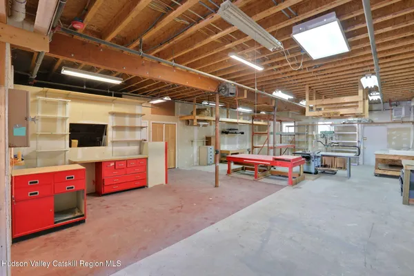 a view of a garage with storage and a barbeque