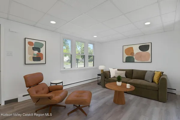 a living room with furniture a rug and a window