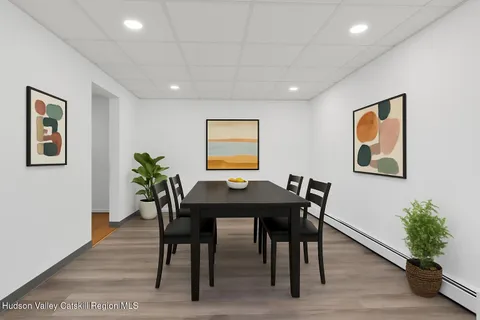 a view of a dining room with furniture window and wooden floor