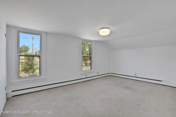 an empty room with windows and closet