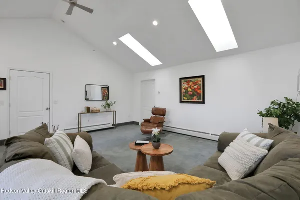 a living room with furniture and a potted plant