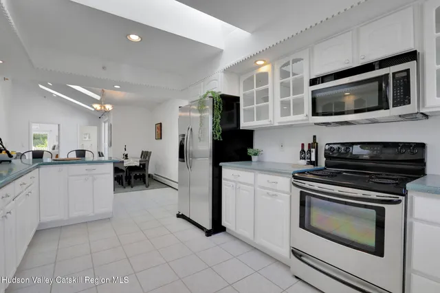 a kitchen with cabinets and steel stainless steel appliances