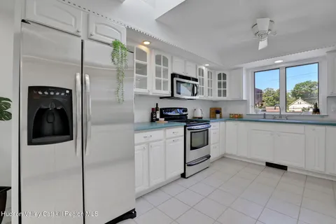a kitchen with a refrigerator and a sink