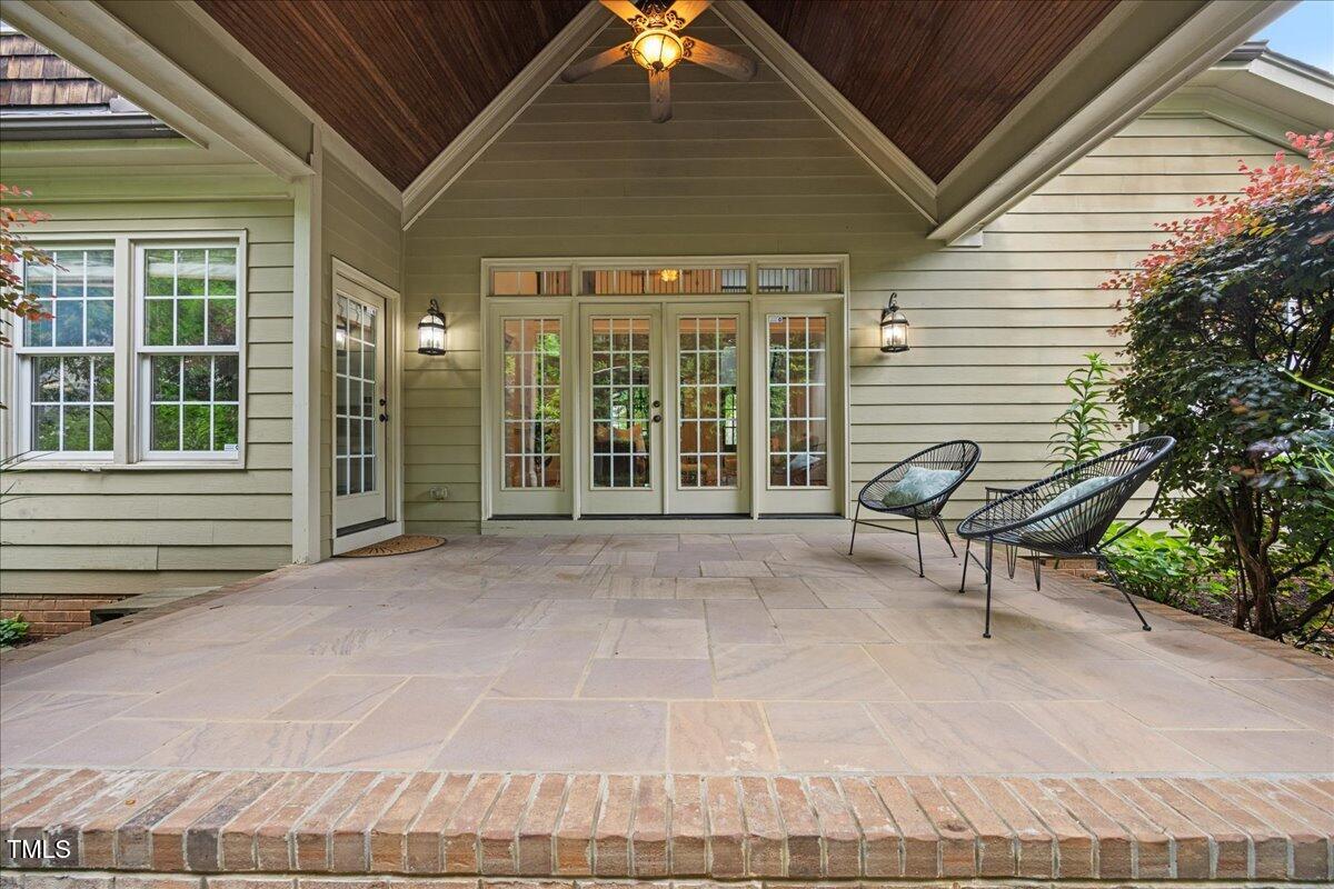 2507 Mayview Road Raleigh, NC 27607 - Photo 12 of 53 Covered stone patio with stained wood ceilings and access to living and kitchen