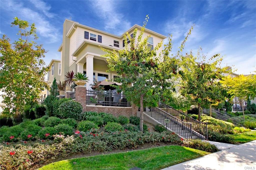 a view of a house with a yard and potted plants