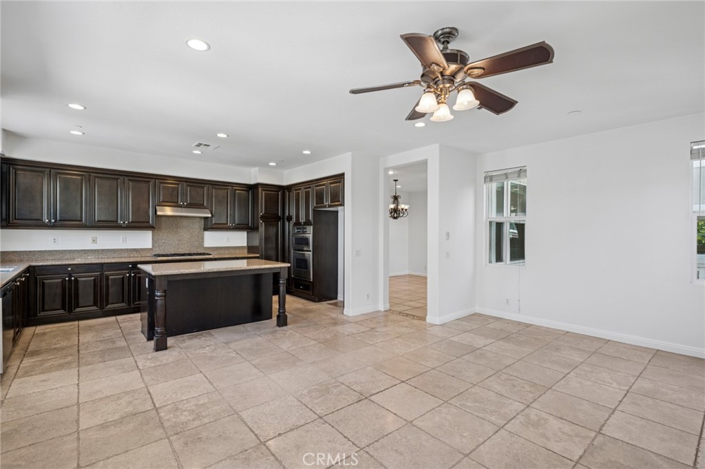 56 Fringe Tree Irvine, CA 92606 - Photo 11 of 26 a large kitchen with stainless steel appliances granite countertop a sink and cabinets