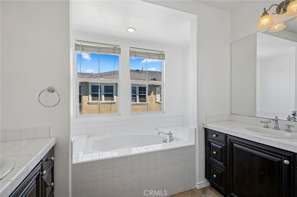 56 Fringe Tree Irvine, CA 92606 - Photo 14 of 26 a bathroom with a tub sink and mirror