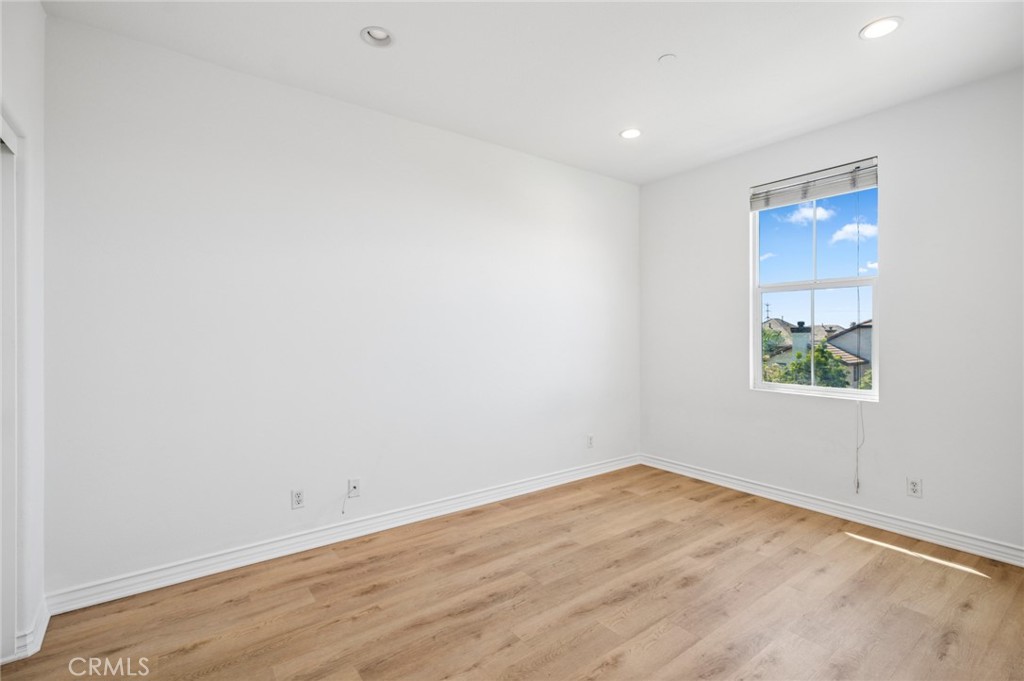 56 Fringe Tree Irvine, CA 92606 - Photo 16 of 26 an empty room with wooden floor and window