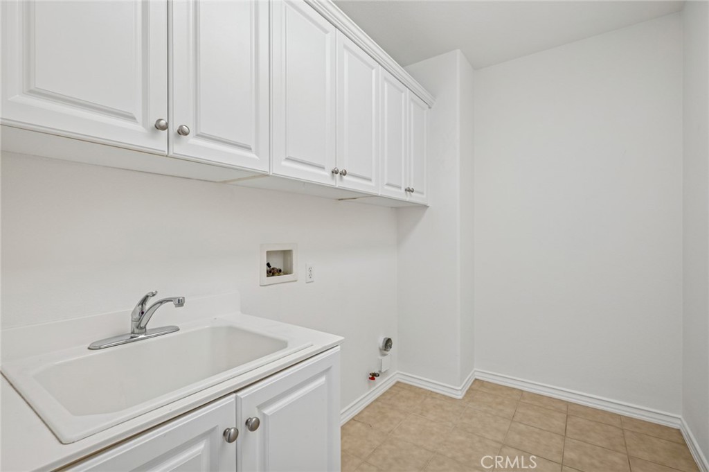 56 Fringe Tree Irvine, CA 92606 - Photo 18 of 26 a bathroom with a sink and cabinets