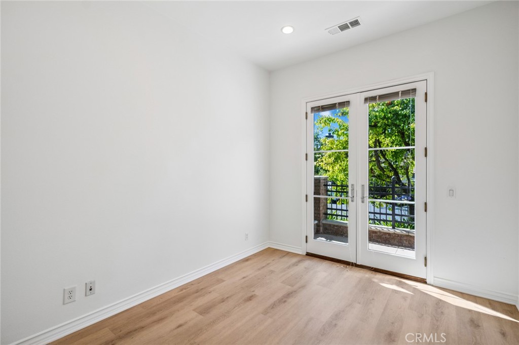 56 Fringe Tree Irvine, CA 92606 - Photo 19 of 26 an empty room with wooden floor and windows