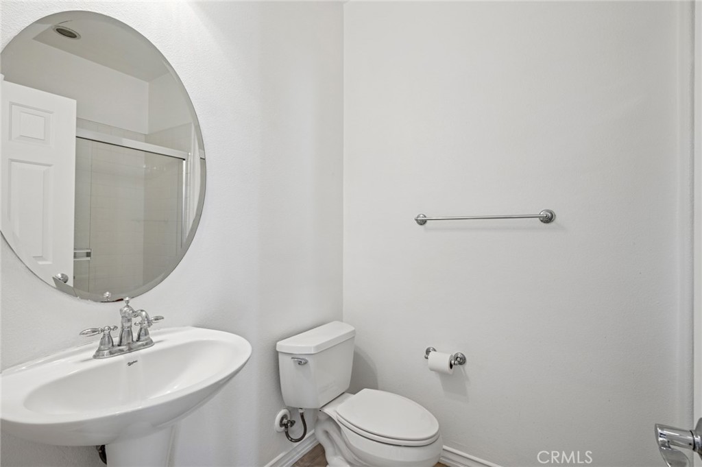 56 Fringe Tree Irvine, CA 92606 - Photo 20 of 26 a bathroom with a toilet a sink and mirror