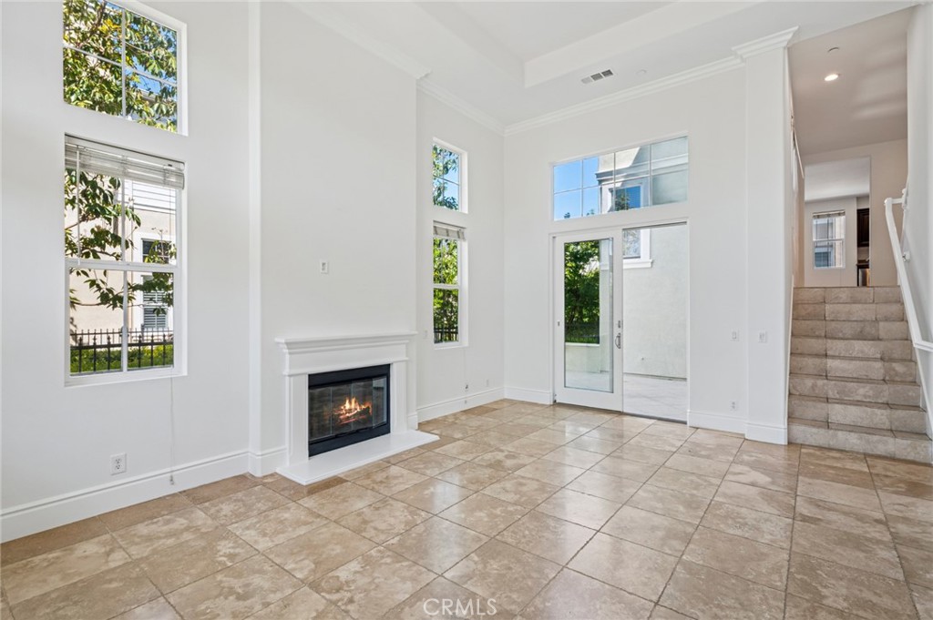 56 Fringe Tree Irvine, CA 92606 - Photo 4 of 26 a view of an empty room with window and fire place