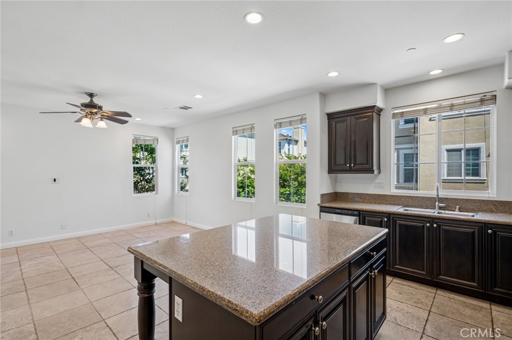 56 Fringe Tree Irvine, CA 92606 - Photo 10 of 26 a kitchen with a stove a sink dishwasher and a refrigerator with wooden floor