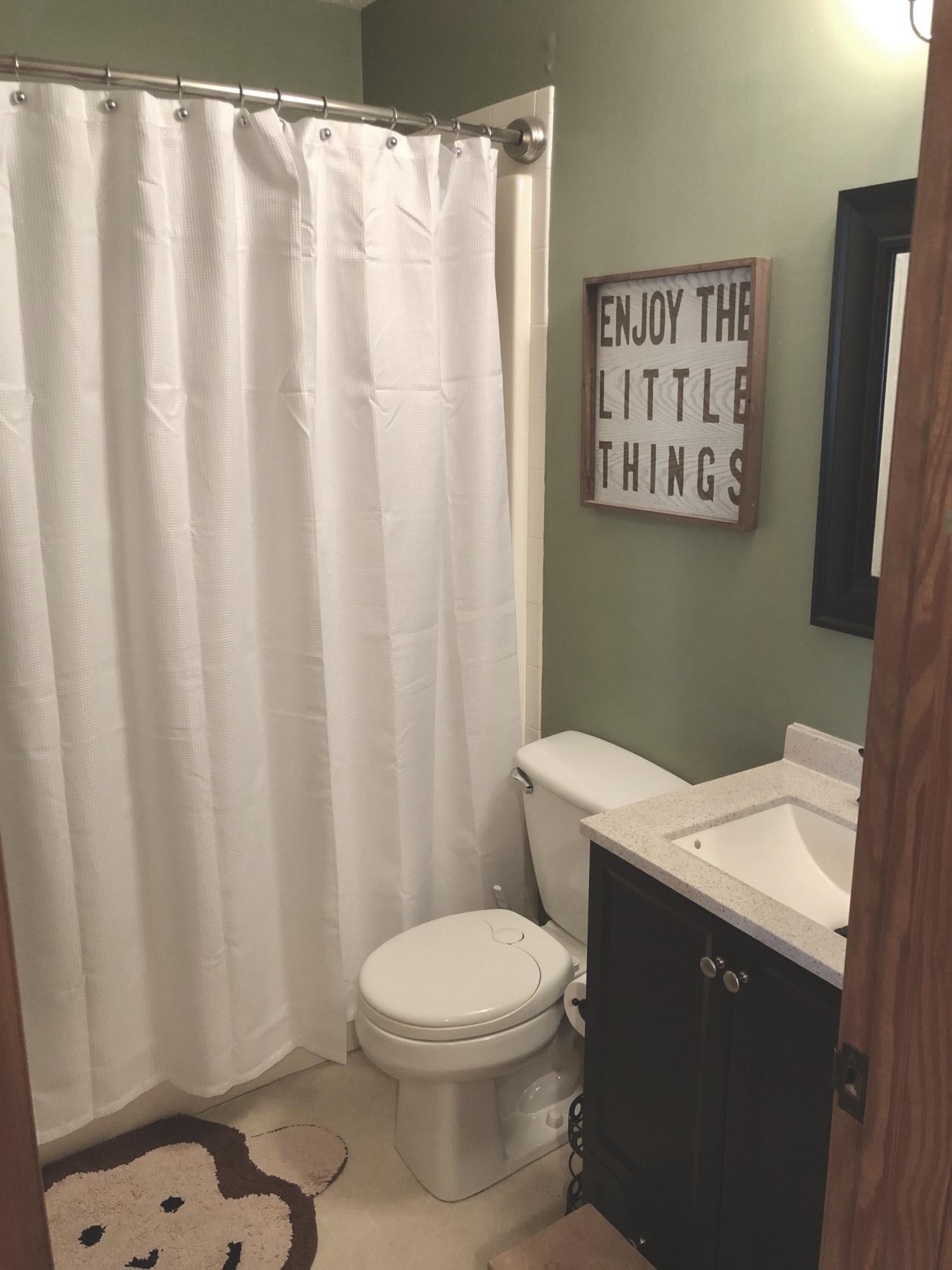 925 Tree Trunk Road Knoxville, TN 37934 - Photo 23 of 32 a bathroom with a toilet a sink and curtain
