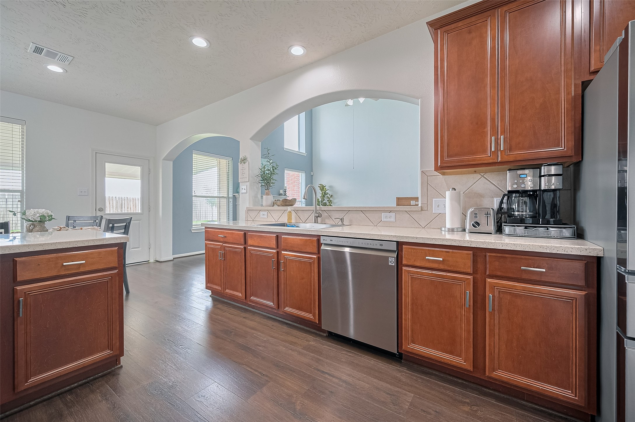 21506 Avalon Queen Drive Spring, TX 77379 - Photo 16 of 48 a kitchen with stainless steel appliances granite countertop wooden cabinets a sink and dishwasher with wooden floor