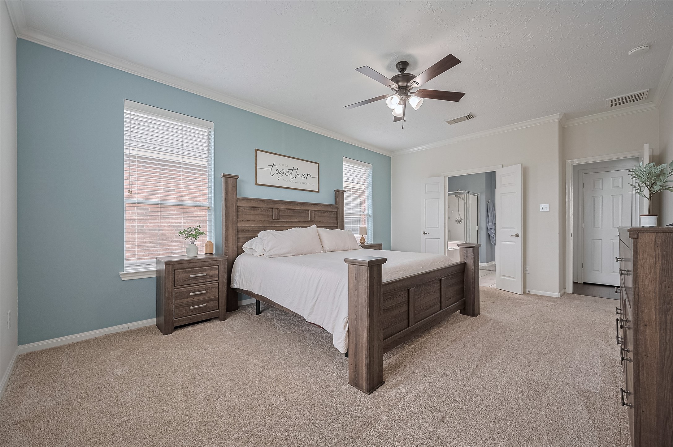 21506 Avalon Queen Drive Spring, TX 77379 - Photo 21 of 48 a spacious bedroom with a bed and a chandelier