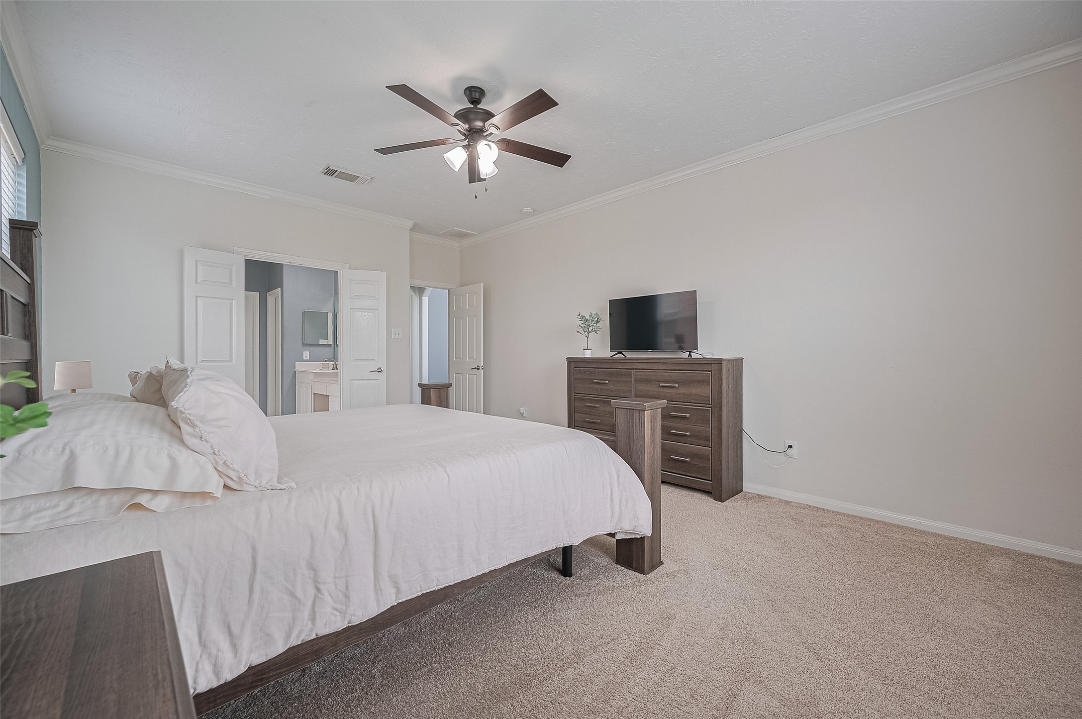 21506 Avalon Queen Drive Spring, TX 77379 - Photo 22 of 48 a bedroom with a bed and a chandelier