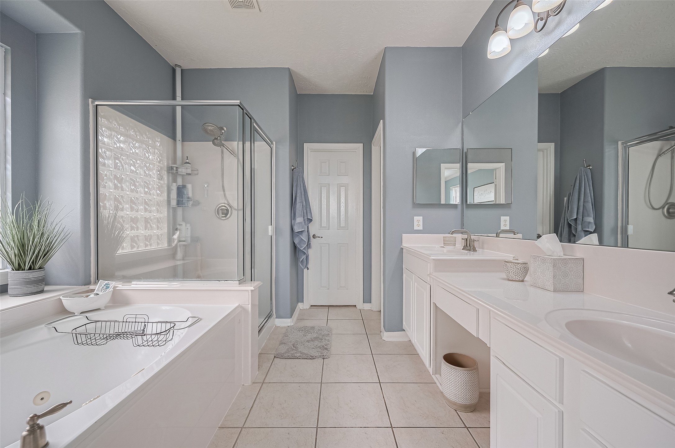 21506 Avalon Queen Drive Spring, TX 77379 - Photo 23 of 48 This spacious bath offers everything for relaxation: a luxurious soaking tub and a separate, glass-enclosed walk-in shower.