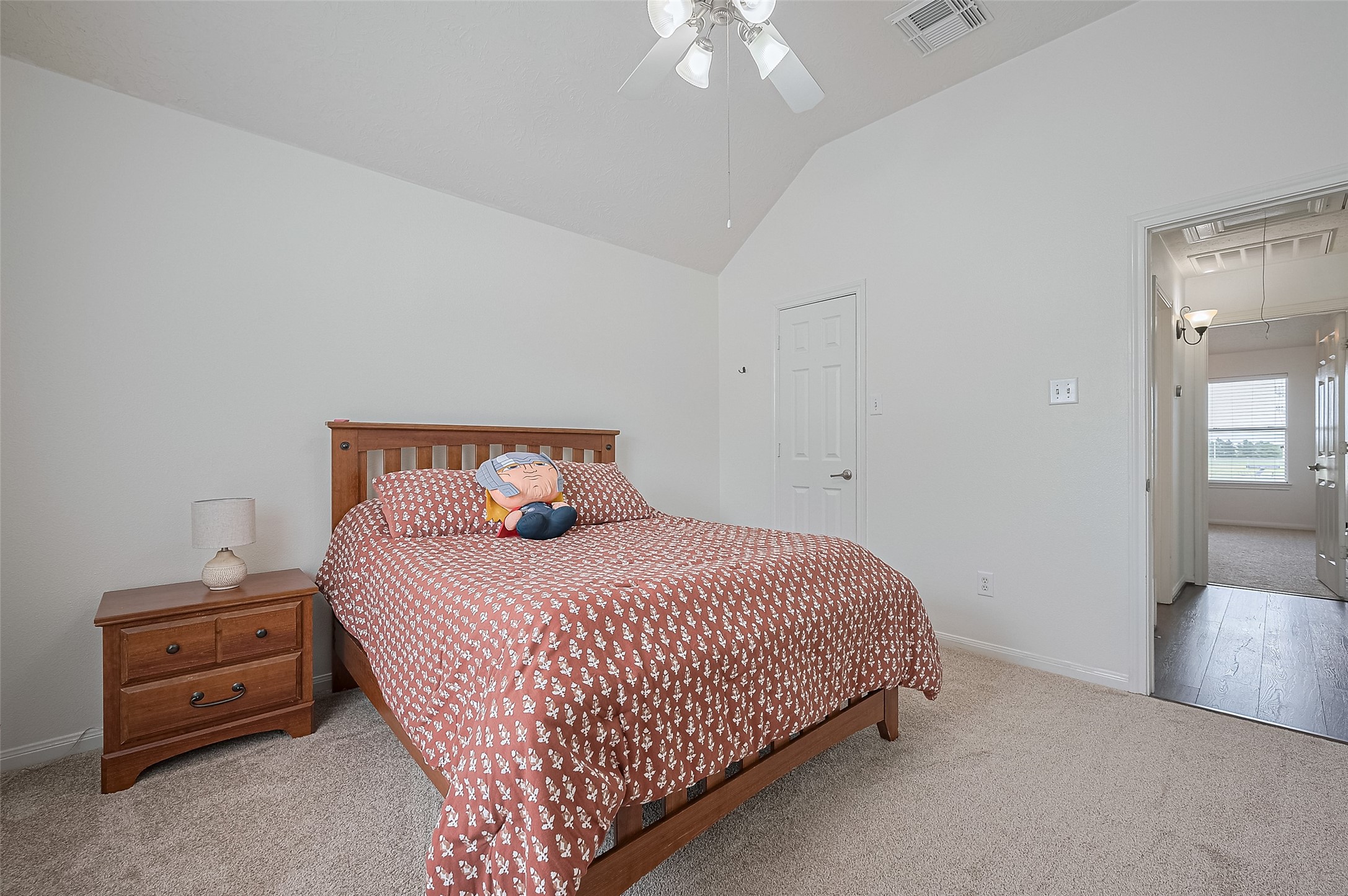 21506 Avalon Queen Drive Spring, TX 77379 - Photo 33 of 48 a bedroom with a bed and a chandelier