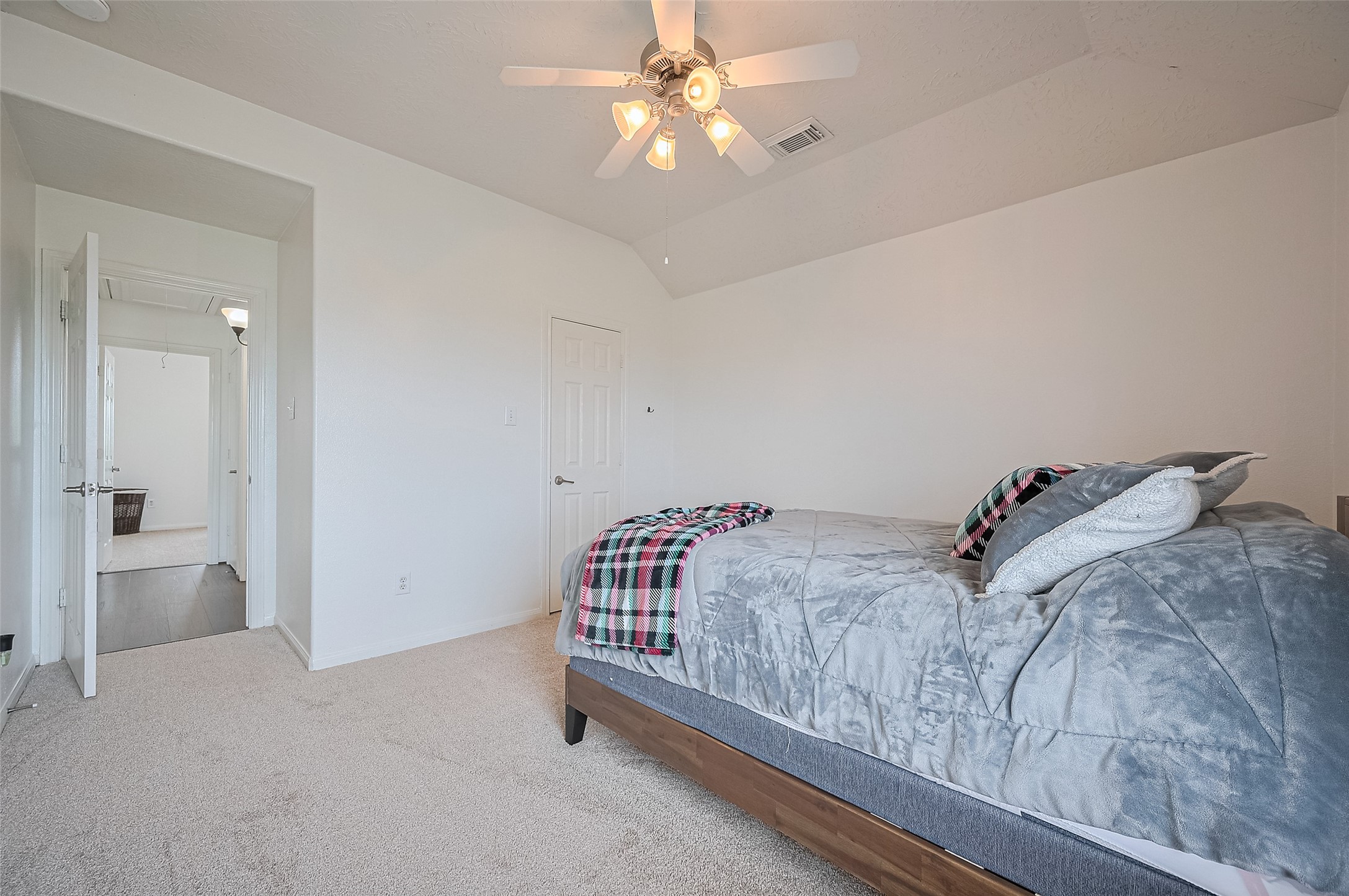 21506 Avalon Queen Drive Spring, TX 77379 - Photo 39 of 48 a bedroom with a bed and a chandelier