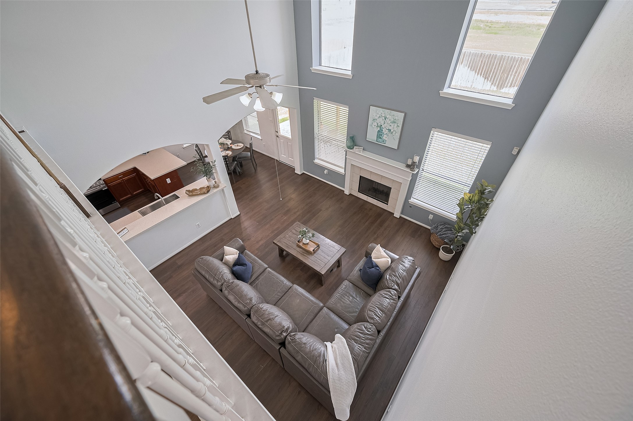 21506 Avalon Queen Drive Spring, TX 77379 - Photo 4 of 48 The dramatic two-story living room offers a stunning view from the second floor, with abundant windows and a fireplace as the focal point.