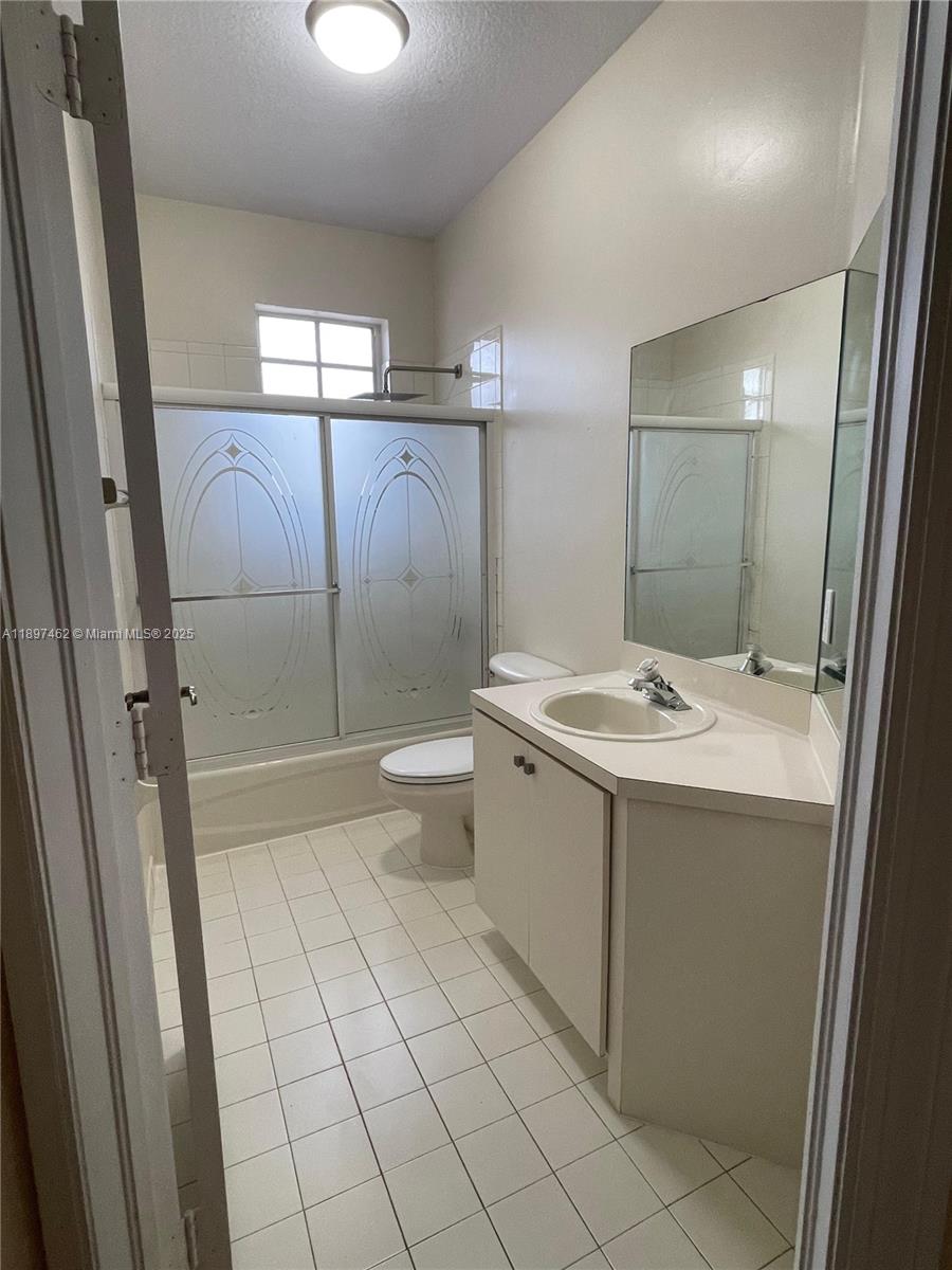 12708 Southwest 49th Drive, Unit 12708 Miramar, FL 33027 - Photo 11 of 14 a bathroom with a sink a toilet and shower