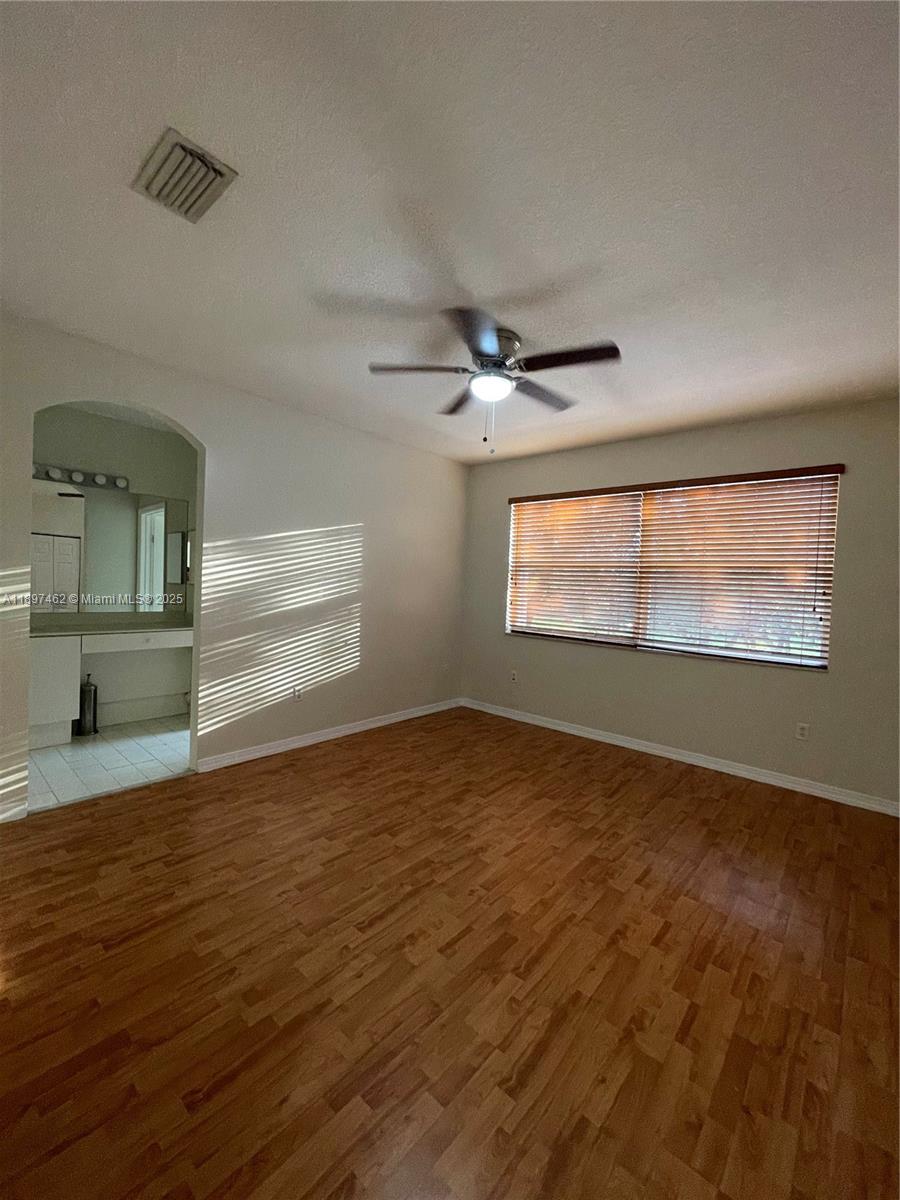 12708 Southwest 49th Drive, Unit 12708 Miramar, FL 33027 - Photo 12 of 14 a view of an empty room with a window and wooden floor