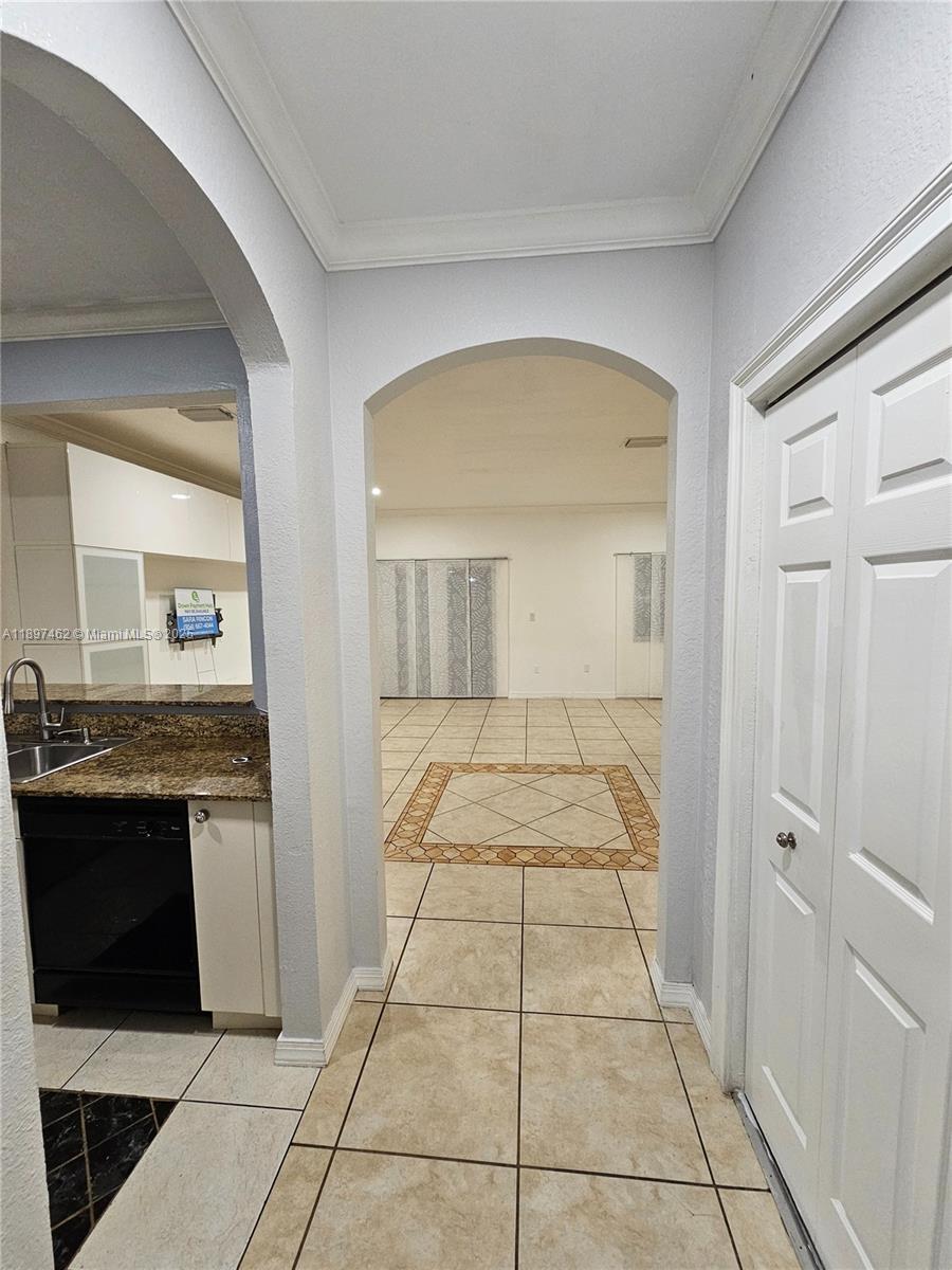 12708 Southwest 49th Drive, Unit 12708 Miramar, FL 33027 - Photo 7 of 14 a view of a hallway to a livingroom with furniture